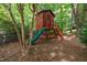 Elevated backyard playhouse with slide, ladder, and fencing at 206 Glebe Way, Cary, NC 27519