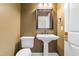 Traditional powder room with pedestal sink, mirror, and white toilet at 206 Glebe Way, Cary, NC 27519