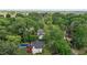An aerial view shows a private pool, deck with umbrellas, and lush, mature trees surrounding the property at 2113 Port Royal Rd, Raleigh, NC 27609