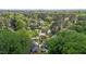 Aerial view showcases a lush, wooded neighborhood with well-maintained homes and mature trees on a sunny day at 2113 Port Royal Rd, Raleigh, NC 27609