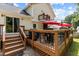 Spacious backyard deck with outdoor furniture and a charming second-story balcony, perfect for relaxation at 2113 Port Royal Rd, Raleigh, NC 27609