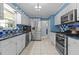 Bright kitchen features stainless steel appliances and blue backsplash at 2113 Port Royal Rd, Raleigh, NC 27609