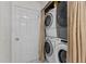 Efficient laundry area with stacked washer and dryer units inside of closet for space-saving convenience at 2113 Port Royal Rd, Raleigh, NC 27609