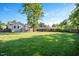 Large green backyard featuring trees, a fence, and an outdoor gazebo at 2210 Milburnie Rd, Raleigh, NC 27610