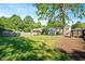 Picture of fenced in green backyard with mature trees and an outdoor gazebo at 2210 Milburnie Rd, Raleigh, NC 27610