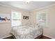 Cozy bedroom with hardwood floors, windows, and neutral décor at 2210 Milburnie Rd, Raleigh, NC 27610