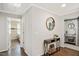 Hallway featuring hardwood floors, a console table, and access to other rooms in the house at 2210 Milburnie Rd, Raleigh, NC 27610