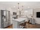 Elegant kitchen featuring stainless appliances, a large island with barstools, and sleek white cabinetry at 2210 Milburnie Rd, Raleigh, NC 27610