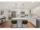 Modern kitchen with stainless steel appliances, quartz countertops, and stylish pendant lighting over island at 2210 Milburnie Rd, Raleigh, NC 27610