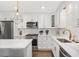 Kitchen with stainless steel appliances, white cabinets, marble countertops, and a subway tile backsplash at 2210 Milburnie Rd, Raleigh, NC 27610