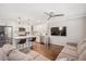Open-concept layout featuring living area with neutral sectional, hardwood floors, and kitchen with bar seating at 2210 Milburnie Rd, Raleigh, NC 27610