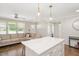 Living room and kitchen view featuring an island with a marble countertop and hardwood floors at 2210 Milburnie Rd, Raleigh, NC 27610