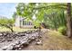 Scenic backyard featuring a rock creek bed, bridge leading to a deck, and mature trees at 2301 Bolingbrook Ln, Raleigh, NC 27613