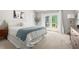 Bright bedroom with king size bed, white bedding, french doors, and exterior balcony at 2301 Bolingbrook Ln, Raleigh, NC 27613