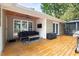 Inviting deck featuring outdoor seating, ceiling fan, and a mounted television for entertainment at 2301 Bolingbrook Ln, Raleigh, NC 27613