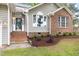 Charming home featuring a brick and vinyl facade, landscaped garden bed, and inviting front entrance at 2301 Bolingbrook Ln, Raleigh, NC 27613