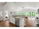 Kitchen with granite countertops and stainless appliances open to the dining and living areas at 2301 Bolingbrook Ln, Raleigh, NC 27613