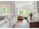 Bright living room with ample seating, views of the outdoors, and seamless transition to adjacent living spaces at 2301 Bolingbrook Ln, Raleigh, NC 27613