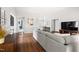 Open living room with wood flooring, neutral walls, comfortable seating, and seamless flow into other areas of the home at 2301 Bolingbrook Ln, Raleigh, NC 27613