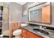 Modern bathroom featuring a walk-in shower, dark marble countertops, and wood paneling at 251 Charles Riddle Rd, Sanford, NC 27330