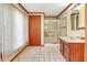 Traditional bathroom with a walk-in shower, wood trim, and a vanity with a marble countertop at 251 Charles Riddle Rd, Sanford, NC 27330