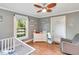 Bedroom with hardwood floors, natural light, and baby furniture at 251 Charles Riddle Rd, Sanford, NC 27330