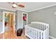 Bedroom with hardwood floors, baby furniture, and a closet at 251 Charles Riddle Rd, Sanford, NC 27330