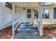 Inviting front entrance with white columns, well-kept stairs, and plants for curb appeal at 251 Charles Riddle Rd, Sanford, NC 27330