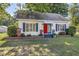 Charming one-story home with a bright red door, tidy landscaping and mature shade trees at 251 Charles Riddle Rd, Sanford, NC 27330