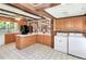Well-appointed kitchen featuring wood cabinets, white countertops, and convenient laundry appliances at 251 Charles Riddle Rd, Sanford, NC 27330