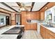 Functional kitchen featuring wood cabinets, white countertops and an electric cooktop at 251 Charles Riddle Rd, Sanford, NC 27330