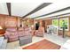 Spacious living area with wood paneled walls, ceiling beams and abundant natural light at 251 Charles Riddle Rd, Sanford, NC 27330