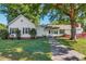 Sprawling one-story home with mature trees and an accessible ramp leading to the entrance at 251 Charles Riddle Rd, Sanford, NC 27330