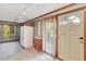 Unfinished room featuring a fridge, concrete floor, and backyard access at 251 Charles Riddle Rd, Sanford, NC 27330