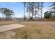Large backyard with a sturdy storage building, retaining wall, and ample space for outdoor enjoyment at 2690 Meadow View Ln, Sanford, NC 27332