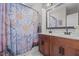 Bathroom featuring double vanity and shower with fun daisy curtain and decor at 2690 Meadow View Ln, Sanford, NC 27332