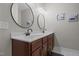Bathroom features a double vanity with modern fixtures, oval mirrors, and beautiful lighting at 2690 Meadow View Ln, Sanford, NC 27332