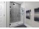 Stylish shower with decorative tile, glass door and subway tile surround creates a spa-like feel at 2690 Meadow View Ln, Sanford, NC 27332