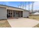 This home features a welcoming covered patio space with wooden columns and ample parking area at 2690 Meadow View Ln, Sanford, NC 27332