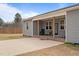 Relax on this home's covered patio with brick trim, wooden columns, and ample parking space at 2690 Meadow View Ln, Sanford, NC 27332