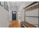 Welcoming entryway featuring hardwood floors, a coat rack, and modern light fixtures at 2690 Meadow View Ln, Sanford, NC 27332