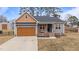 Charming home with gray siding, a welcoming front porch, and a well-maintained front yard at 2690 Meadow View Ln, Sanford, NC 27332