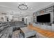 Spacious living room with a large sectional, built-in shelving, and modern lighting at 2690 Meadow View Ln, Sanford, NC 27332