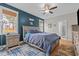 Comfortable main bedroom with a large bed, blue accent wall, and ensuite bathroom at 2690 Meadow View Ln, Sanford, NC 27332