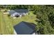 Spacious property showcasing a well-kept lawn, a home with a dark roof, and inviting backyard spaces at 2717 Jack Rd, Clayton, NC 27520