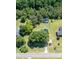 Aerial view of the home and garage situated on a spacious lot with mature trees and a well-maintained lawn at 2717 Jack Rd, Clayton, NC 27520