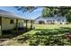 Expansive backyard with lush lawn, mature trees, storage shed, and patio offers ample outdoor space at 2717 Jack Rd, Clayton, NC 27520