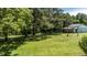 Lush green lawn in the backyard bordered by trees, creating a private and serene outdoor space at 2717 Jack Rd, Clayton, NC 27520