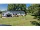 Spacious backyard featuring a deck, mature trees, and a well-maintained lawn, perfect for outdoor activities and relaxation at 2717 Jack Rd, Clayton, NC 27520