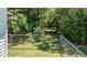Fenced backyard with a gate leading to a wooded area, offering privacy and potential for nature exploration at 2717 Jack Rd, Clayton, NC 27520